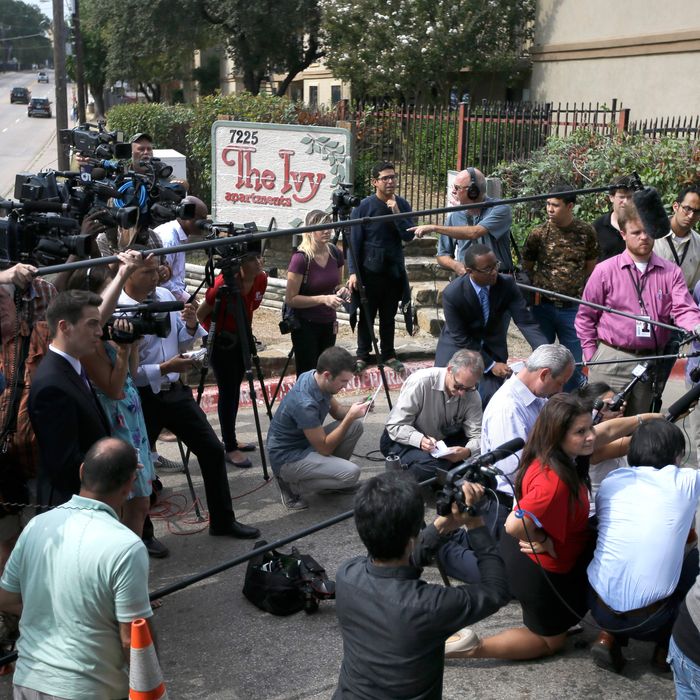 Sally Nuran, far right, in front of microphones, manager of the Ivy Apartments, responds to questions from reporters during a news conference at the main entrance to the complex, Thursday, Oct. 2, 2014, in Dallas. 