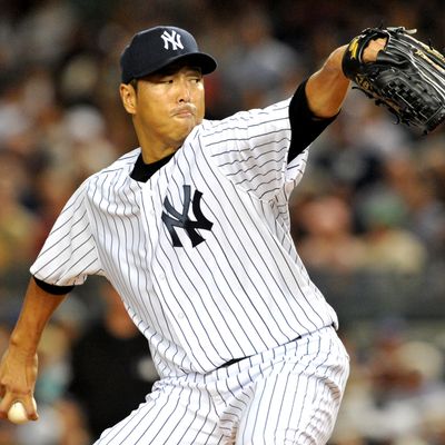 Hiroki Kuroda #18 of the New York Yankees pitches against the Boston Red Sox at Yankee Stadium on August 19, 2012 in the Bronx borough of New York City.