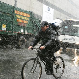 A bicycle courier rides during a brief s