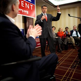 Texas Gov. Rick Perry speaks with potential voters during a caucus training session on January 3, 2012.