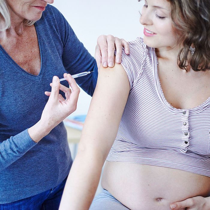 Pregnant woman getting a vaccine.