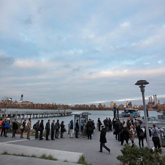 Morning commuters line up to take a Manhattan-bound ferry in the Brooklyn borough of New York, U.S., on Monday, Nov. 5, 2012. Commuters in New York and New Jersey face gasoline lines and miles of traffic jams as the metropolitan area struggles with the chaos that remains in the wake of superstorm Sandy.