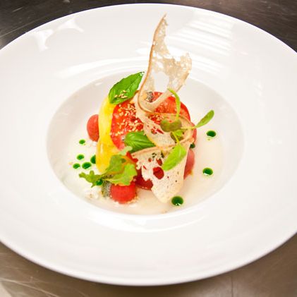 Toy box tomatoes with burrata, basil, and sesame.