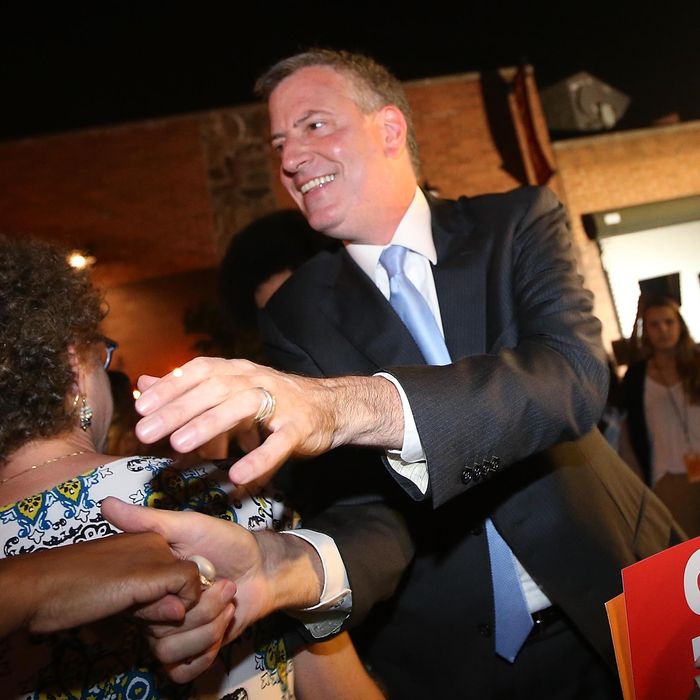 NEW YORK, NY - SEPTEMBER 10: Democratic candidate for mayor and Public Advocate Bill de Blasio (C) greets the crowd while arriving at his primary night party on September 10, 2013 in the Brooklyn borough of New York City. De Blasio is leading the Democratic race, according to exit polls. (Photo by Mario Tama/Getty Images)