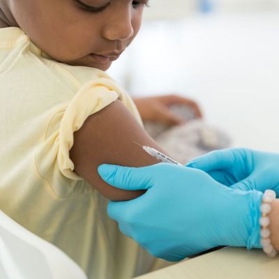 Close up vaccination of a little boy on his arm in a doctor’s office.