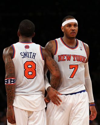 Carmelo Anthony #7 and J.R. Smith #8 of the New York Knicks celebrate a foul against the Dallas Mavericks on November 9, 2012 at Madison Square Garden in New York City.The New York Knicks defeated the Dallas Mavericks 104-94.