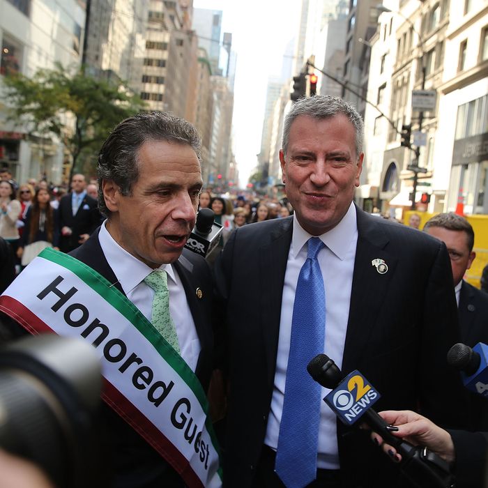 NEW YORK, NY - OCTOBER 14: Democratic new York City mayoral candidate Bill de Blasio (R) speaks with New York Governor Andrew Cuomo while marching in the 69th Annual Columbus Day Parade on October 14, 2013 in New York City. With dozens of floats, marching bands and politicians on hand, the annual celebration of Italian American culture and heritage draws large crowds along 5th Avenue. (Photo by Spencer Platt/Getty Images)