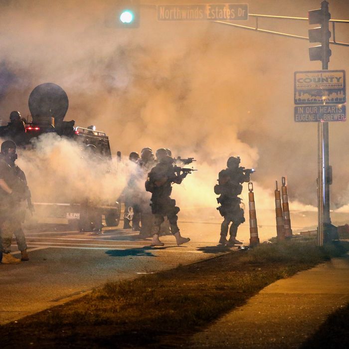 FERGUSON, MO - AUGUST 18: Police attempt to control demonstrators protesting the killing of teenager Michael Brown on August 18, 2014 in Ferguson, Missouri. Police shot smoke and tear gas to disperse the protestors with as they became unruly. Brown was shot and killed by a Ferguson police officer on August 9. Despite the Brown family's continued call for peaceful demonstrations, violent protests have erupted nearly every night in Ferguson since his death. (Photo by Scott Olson/Getty Images)