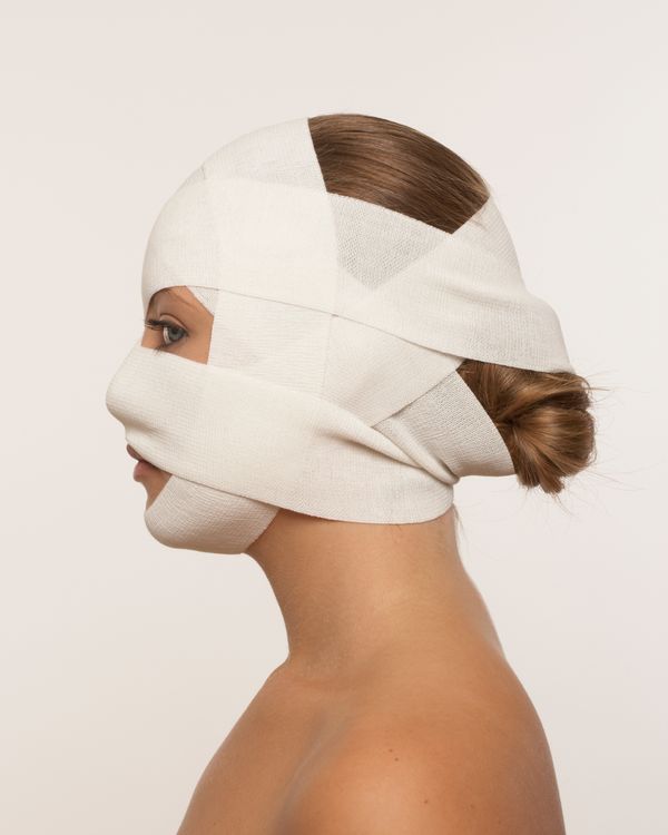 Young woman with bandaged face, profile