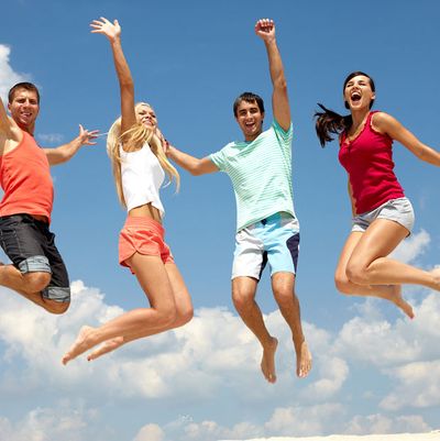 Portrait of four jumping happy people