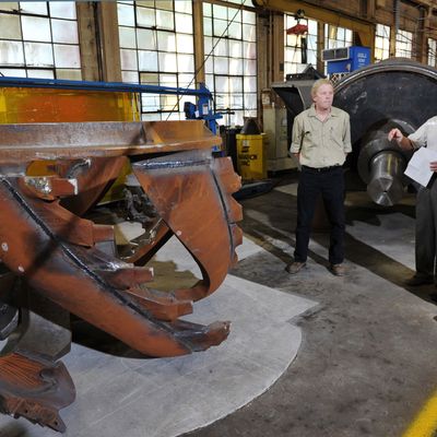 US President Barack Obama(R) looks at dredging equipment which will be heading to Bangladesh during a tour of Ellicott Dredges with Ellicott Dredges President Peter Bowe on May 17, 2013 in Baltimore, Maryland. Obama is visiting Baltimore on what the administration called 