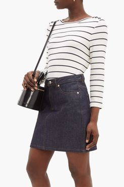A.P.C. Myrtille Breton-Striped Top A ribbed long sleeve white shirt with thin navy stripes tucked into a dark wash jean skirt and a small black patent bucket bag. The Strategist - 48 Things on Sale You’ll Actually Want to Buy: From Sunday Riley to Patagonia