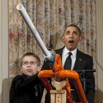 US President Barack Obama reacts as 14-year-old Joey Hudy of Phoenix, Arizona, launches a marshmallow from Hudy's 