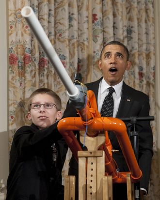 US President Barack Obama reacts as 14-year-old Joey Hudy of Phoenix, Arizona, launches a marshmallow from Hudy's 