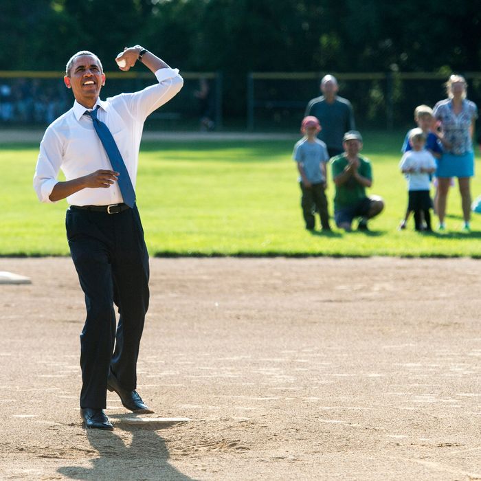  U.S. President Barack Obama throws out the first pitch at a little league baseball game at Friendship Park May 19, 2014 in Washington, DC. 