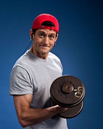 Paul Ryan in a red cap, lifting weights.