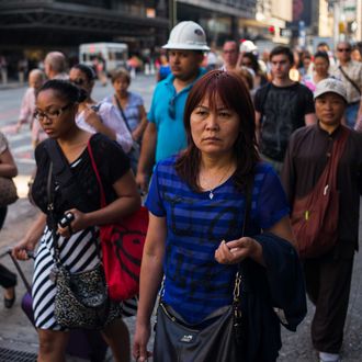 NEW YORK, NY - JULY 7: Morning commuters walk to their offices July 7, 2014 across from the Port Authority Bus Terminal in the Manhattan borough of New York City. (Photo by Robert Nickelsberg/Getty Images)