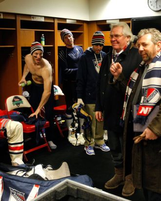 General manager Glen Sather and James Dolan, President and CEO of Cablevision Systems Corporation and Executive Chairman of Madison Square Garden, speak to the New York Rangers after they defeated the Philadelphia Flyers in the 2012 Bridgestone NHL Winter Classic at Citizens Bank Park on January 2, 2012 in Philadelphia, Pennsylvania.