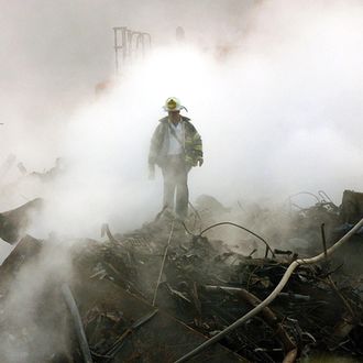 A fireman walks amongst the rubble and the smoldering wreckage of the World Trade Center 11 October 2001 in New York. An interfaith ceremony was held at ground zero in conjunction with the one month anniversary of the attacks, marked by the short prayer service and a moment of silence at 8:48am. AFP Photo/POOL/Gary Friedman (Photo credit should read GARY FRIEDMAN/AFP/Getty Images)