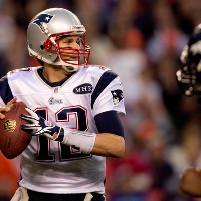 Quarterback Tom Brady #12 of the New England Patriots drops back to pass during the third quarter against the Denver Broncos at Sports Authority Field at Mile High on December 18, 2011 in Denver, Colorado. 