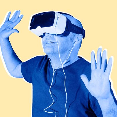 Man wearing ZEISS VR ONE virtual reality VR plastic goggles with bracket for Samsung Galaxy S5 Android smartphone and in-ear headphones, hands up