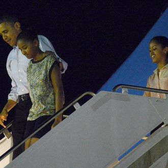 HONOLULU, HI - DECEMBER 22: US President Barack Obama disembarks Obama Air Force One with daughters Natasha and Malia at Joint Base Pearl Harbor-Hickam on December 22, 2012 in Honolulu, Hawaii. Hawaii. The president and his family spend the Christmas holiday in Hawaii, Obama's birthplace. (Photo by Cory Lum-Pool/Getty Images)