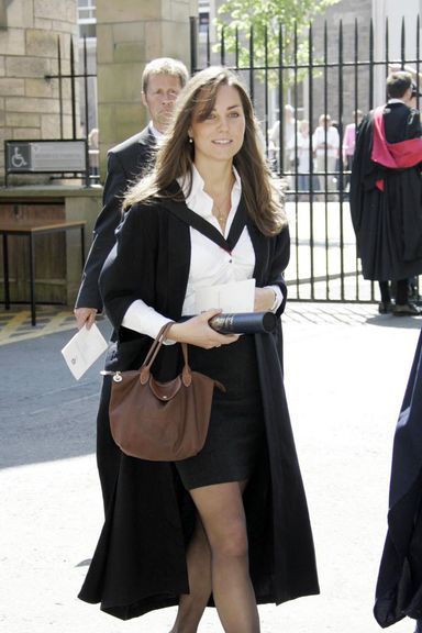 Kate Middleton, the girlfriend of Britain’s Prince William walks during her graduation ceremony at St Andrews, Scotland, 23 June 2005. Prince William, the second in line to the British throne, graduated from university 23 June to embark on a new chapter in his life, which will include work experience in London and a possible army career. The 23-year-old said he was entering the “big wide world” after gaining a masters degree in geography from St. Andrews University, Scotland, where he has spent the past four years tucked away from the prying eyes of the media.   AFP PHOTO/Michael Dunlea/POOL (Photo credit should read MICHAEL DUNLEA/AFP/Getty Images)