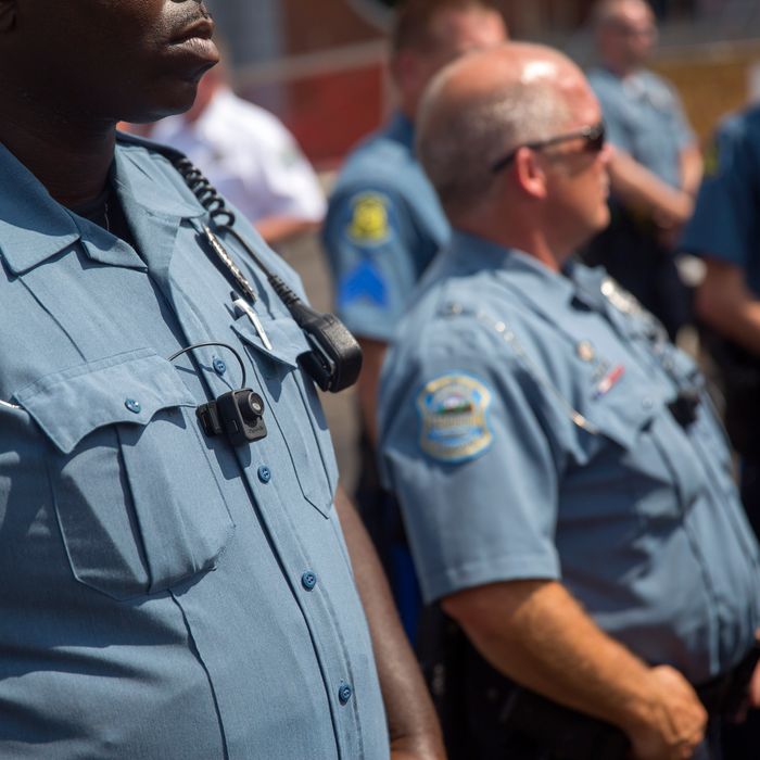 FERGUSON, MO - AUGUST 30: Members of the Ferguson Police department wear body cameras during a rally August 30, 2014 in Ferguson, Missouri. Michael Brown, an 18-year-old unarmed teenager, was shot and killed by Ferguson Police Officer Darren Wilson on August 9. His death caused several days of violent protests along with rioting and looting in Ferguson. (Photo by Aaron P. Bernstein/Getty Images)