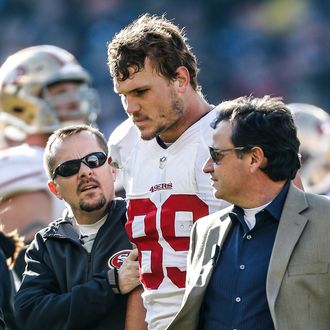 CHICAGO, IL - DECEMBER 6: Vice President of Football Operations Jeff Ferguson of the San Francisco 49ers helps Vance McDonald #89 for a concussion test during the game against the Chicago Bears at Soldier Field on December 6, 2015 in Chicago, Illinois. The 49ers defeated the Bears 26-20. (Photo by Michael Zagaris/San Francisco 49ers/Getty Images)