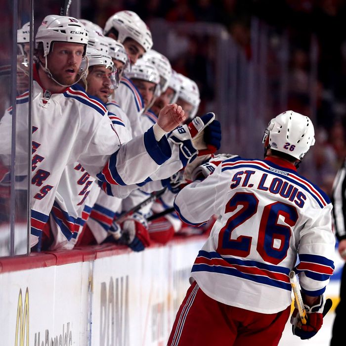 Martin St. Louis #26 of the New York Rangers celebrates with his teammates on the bench after scoring a goal against Dustin Tokarski #35 of the Montreal Canadiens during the second period in Game Two of the Eastern Conference Final during the 2014 Stanley Cup Playoffs at Bell Centre on May 19, 2014 in Montreal, Canada. 