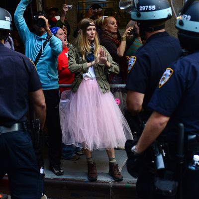 Participants in Occupy Wall Street protest take part in a rally to mark the one year anniversary of the movement in New York, September 17, 2012. Police in New York on Monday arrested at least a dozen demonstrators marking the one-year anniversary of the Occupy Wall Street movement, witnesses said. At least eight people were taken into custody when they tried to block an entrance to Wall Street, representatives of the National Lawyers Guild at the scene, told AFP. Others were arrested when they started moving from Zuccotti Park toward Wall Street as police on horseback blocked side streets on horseback, according to an AFP reporter at the scene. AFP PHOTO/Emmanuel Dunand (Photo credit should read EMMANUEL DUNAND/AFP/GettyImages)