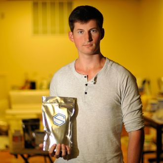 Soylent CEO Rob Rhinehart holds a bag of finished product inside a warehouse in Oakland, California where the company runs its business on September 09, 2013. The 24-year-old software engineer developed Soylent, a homemade nutrient concoction, designed as part meal-replacement drink, part thought experiment, providing every necessary nutrient while challenging societys current perception of nutrition. AFP PHOTO/Josh Edelson (Photo credit should read Josh Edelson/AFP/Getty Images)