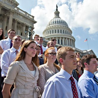 College students wait on the steps of the House of Representatives for Speaker of the House John Boehner, R-Ohio, and GOP leaders to arrive for a news conference on federal student loan rates which doubled on July 1, at the Capitol in Washington, Monday, July 8, 2013. (AP Photo/J. Scott Applewhite)