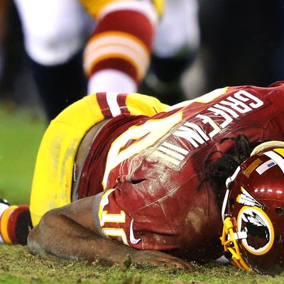 Robert Griffin III #10 of the Washington Redskins is injured as he fumbles a low snap in the fourth quarter against the Seattle Seahawks during the NFC Wild Card Playoff Game at FedExField on January 6, 2013 in Landover, Maryland.