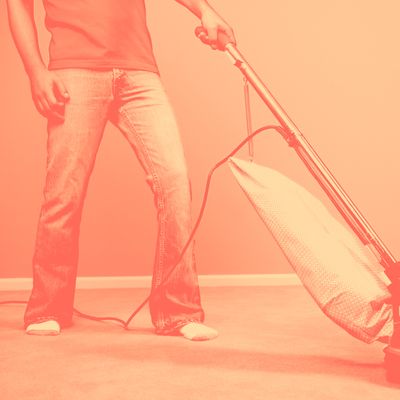 Low section of young man vacuuming