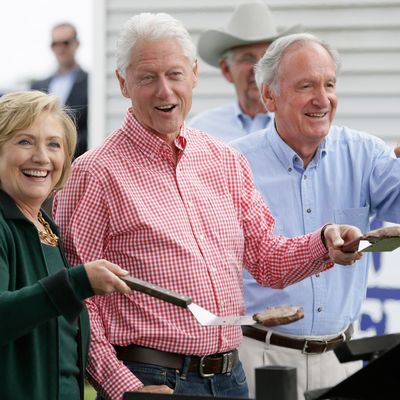 Former Sec. of State Hillary Rodham Clinton, former President Bill Clinton and U.S. Sen. Tom Harkin work the grill during Harkin's annual fundraising Steak Fry, Sunday, Sept. 14, 2014, in Indianola, Iowa. (AP Photo/Charlie Neibergall)