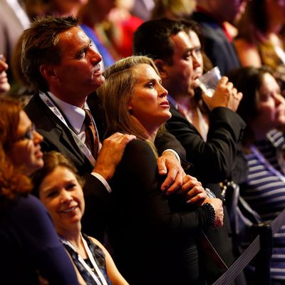 People standing in the crowd react while watching election results displayed on a television during Mitt Romney's campaign election night event at the Boston Convention & Exhibition Center on November 6, 2012 in Boston, Massachusetts. Voters went to polls in the heavily contested presidential race between incumbent U.S. President Barack Obama and Republican challenger Mitt Romney. 