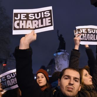 People hold placards reading in French 