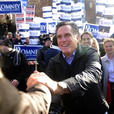Republican presidential hopeful Mitt Romney greets voters outside a polling station at Webster School in Manchester, New Hampshire, January 10, 2012. 