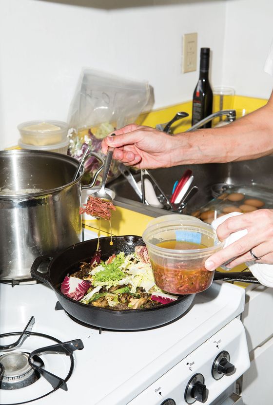 Saffer spooning soppressata sauce over the wild mushrooms and chicory.