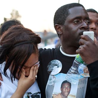 NEW YORK, NY - MARCH 22: Jazzminn Mack (L), girlfriend of Ramarley Graham, cries while Franclot Graham, father of Ramarley Graham, speaks during a vigil for his son outside New York City Police Department's 47th Precinct on March 22, 2012 in the Bronx borough New York City. Graham, 18, was shot in the chest by police officers in his grandmother's bathroom after the officers entered the house without a warrent. Graham, was unarmed; he was attempting to flush a bag of marijuana down the toilet. (Photo by Andrew Burton/Getty Images)