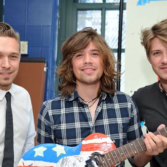 NEW YORK - OCTOBER 22: (L-R) Zac Hanson, Taylor Hanson, and Isaac Hanson of the band Hanson hold a guitar painted by the band during the VH1 Save the Music Foundation Family Day at the The Anderson School on October 22, 2011 in New York City. (Photo by Mike Coppola/Getty Images)