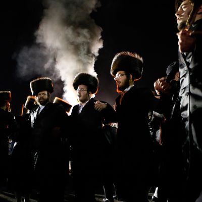 Orthodox Jews of the Satmar Hasidim dance as they celebrate the Jewish holiday of Lag Ba'Omer in the village of Kiryas Joel, New York May 18, 2014. Lag Ba'Omer marks the anniversary of the death of Talmudic sage Rabbi Shimon Bar Yochai approximately 1,900 years ago. Thousands of the Satmar, who are opposed on principle to the existence of the state of Israel, danced near a bonfire into the night. 