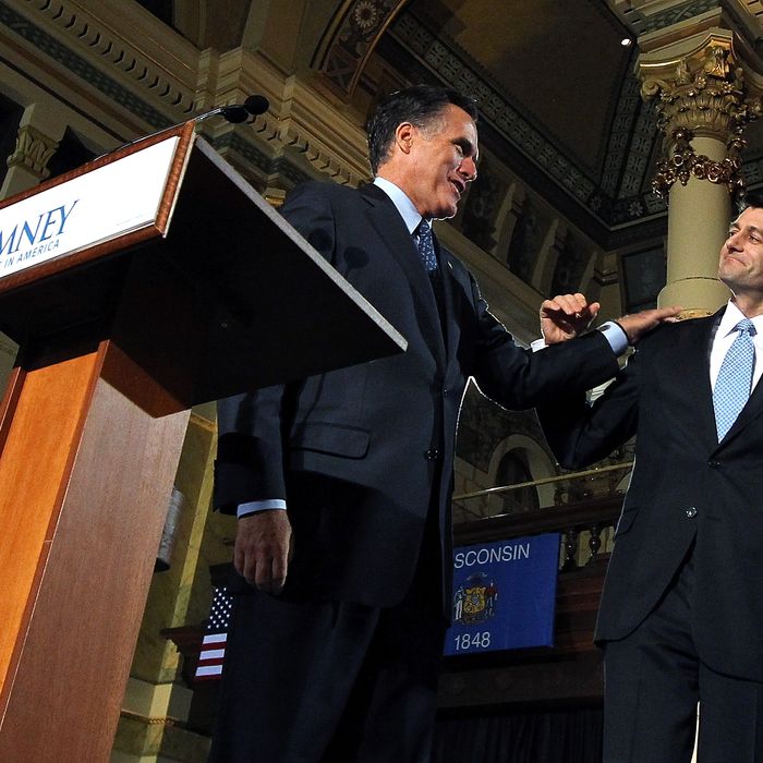 Republican presidential candidate, former Massachusetts Gov. Mitt Romney (L) greets U.S. Rep. Paul Ryan (R-WI) before speaking to supporters during his primary night gathering at The Grain Exchange on April 3, 2012