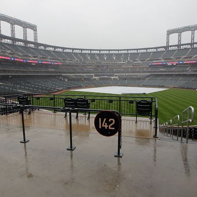 NEW YORK, NY - AUGUST 09: The field is covered as the rain comes down preventing the teams from taking batting practice before the start of a Major League Baseball game between the New York Mets and the San Diego Padres at Citi Field on August 9, 2011 in the Flushing neighborhood of the Queens borough of New York City. (Photo by Paul Bereswill/Getty Images)