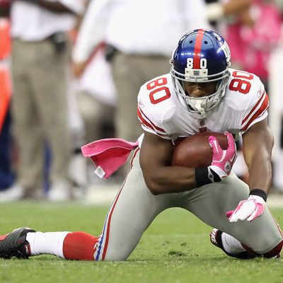 Wide receiver Victor Cruz #80 of the New York Giants falls to the ground untouched after a reception against the Arizona Cardinals during the fourth quarter of the NFL game at the University of Phoenix Stadium.