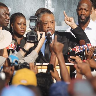 SANFORD, FL - MARCH 22: Rev. Al Sharpton (C) speaks at a rally with Tracy Martin (R), and Sybrina Fulton (2nd L), parents of slain teenager Trayvon Martin, on March 22, 2012 in Sanford, Florida. Sanford Police Department Chief Bill Lee announced today he will temporarily step down following the killing of the black unarmed teenager by a white and Hispanic neighborhood watch captain. Sharpton organized today's rally. (Photo by Mario Tama/Getty Images)