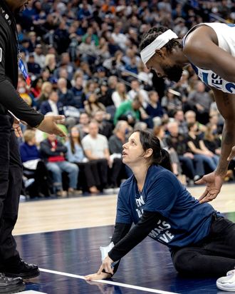 An animal-rights protester tries gluing her hand to the basketball court during a Minnesota Timberwolves game.
