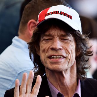 British musician Mick Jagger waves during a closing ceremony ahead of the final football match between Germany and Argentina for the FIFA World Cup at The Maracana Stadium in Rio de Janeiro on July 13, 2014. AFP PHOTO / GABRIEL BOUYS (Photo credit should read GABRIEL BOUYS/AFP/Getty Images)