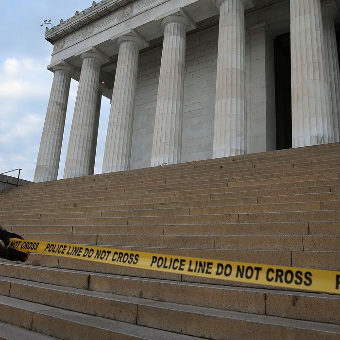WASHINGTON, DC - OCTOBER 01: A U.S. Park Police officer uses police tape to close the Lincoln Memorial, October 1, 2013 in Washington, DC. The National Mall and all monuments and large sections of the government will close due to government shut down after Congress failed to agree on spending. (Photo by Mark Wilson/Getty Images)